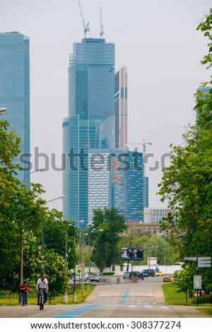 Moscow, Russia - May 24, 2015: People walking in the park of Victory in Moscow. In the background you can see one of the buildings of the business district Moscow City.