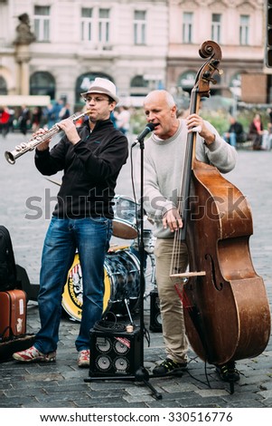 PRAGUE, CZECH REPUBLIC - OCTOBER 10, 2014: Street Busker performing jazz songs at the Old Town Square in Prague. Busking is legal form of earning money on Prague Streets.