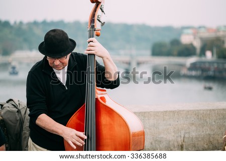 Prague, Czech Republic - October 10, 2014: Street Busker performing jazz songs at the Charles Bridge in Prague. Busking is legal form of earning money on Prague Streets.