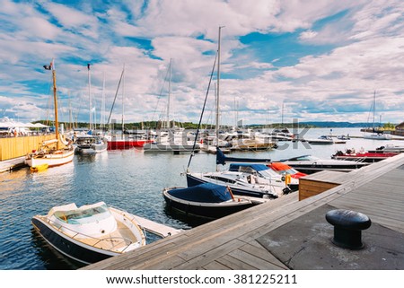 Yachts moored at town quay In Sunny Summer Day. District Aker Brygge in Oslo, Norway. Summer Evening