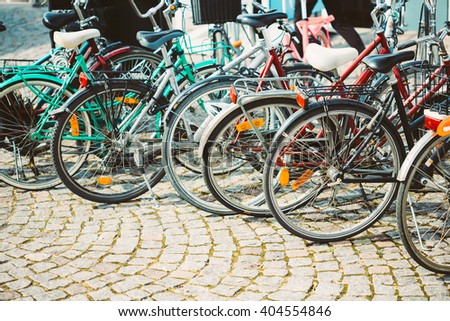 Parked Bicycles On Sidewalk. Bike Bicycle Parking In Big City. Toned Instant Photo
