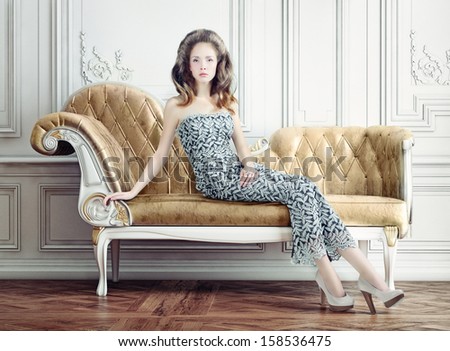 young beautiful lady on the vintage sofa