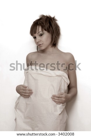 young girl in white cloth near light wall