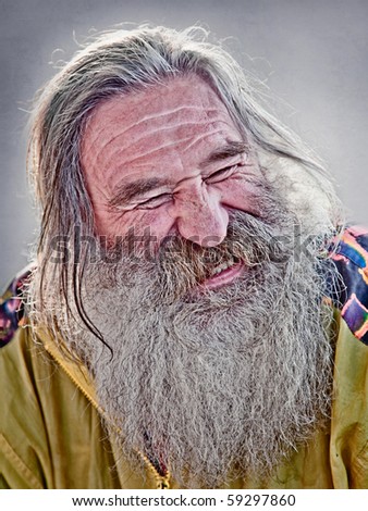 portrait of laughing old man with gray beard