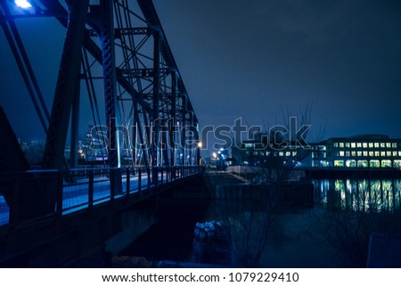 Vintage industrial railroad bridge crossing the Chicago river at night