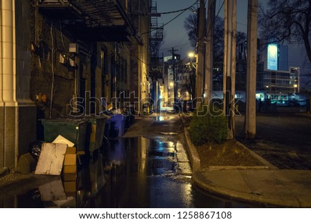 Dark city alley after a rain at night