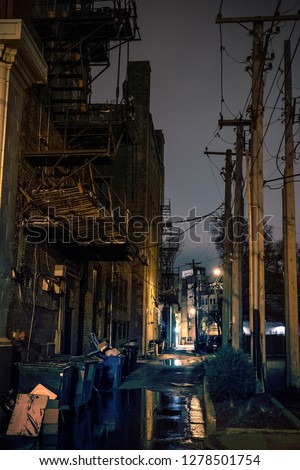 Dark city alley after a rain at night