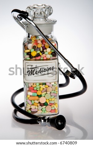 Retro medical concept featuring antique pill bottle and old stethoscope
