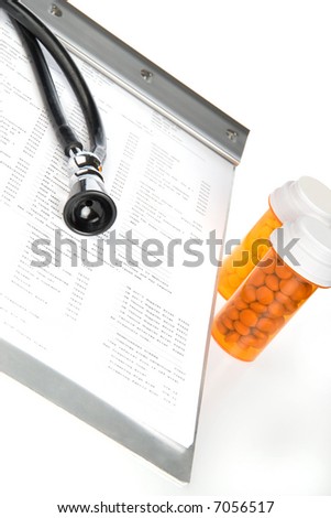 Health care concept featuring lab test results, pill bottles and stethoscope