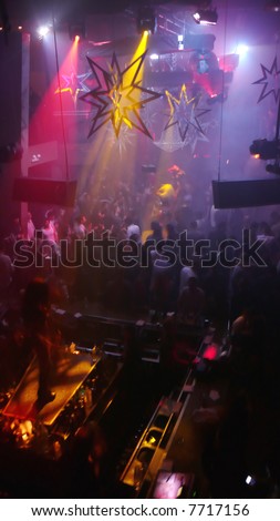 Nightclub scene with christmas decor, dancer and dance floor crowd in motion