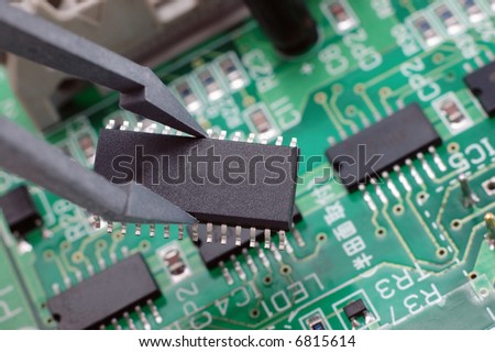 holding an integrated circuit chip with printed circuit board as back ground