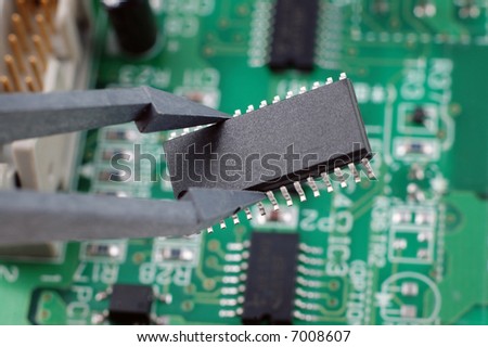 holding an integrated circuit chip with printed circuit board as back ground