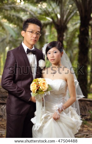 Asian Chinese wedding couple with forest background