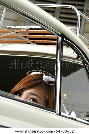 stock-photo-a-girl-hiding-inside-an-antique-car-64788652.jpg