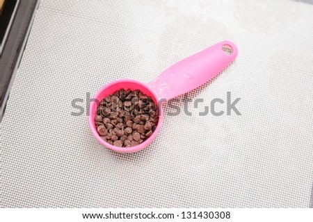 chocolate chips in measuring spoon