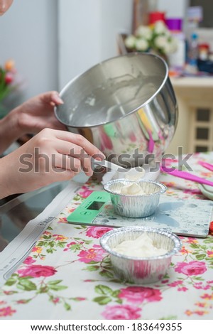 the making of blueberry cheese pie, pouring cream cheese into cup