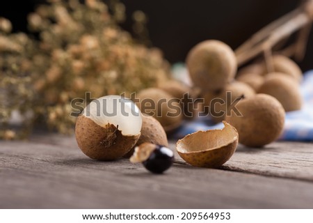 Longan (Dimocarpus longan.) on wood table. with low key scene.