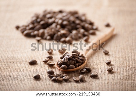 Light roasted coffee beans on sackcloth.