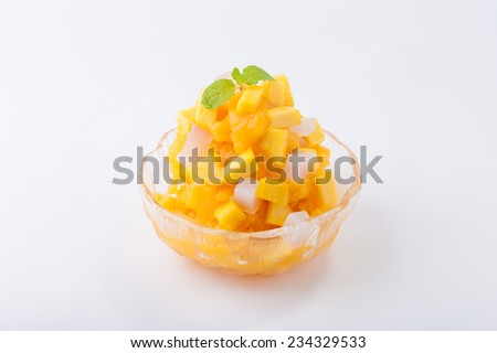 Mango flavoured shave ice with pieces of mango and coconut jelly.