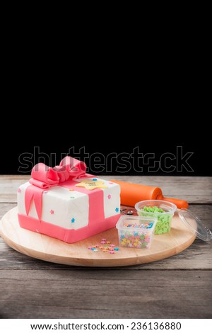 New year present concept fondant cake on wood table.