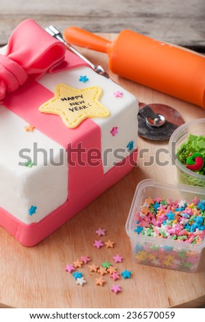 New year present concept fondant cake on wood table.