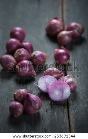 Shallots (red onion) set up on wood table with night scene.