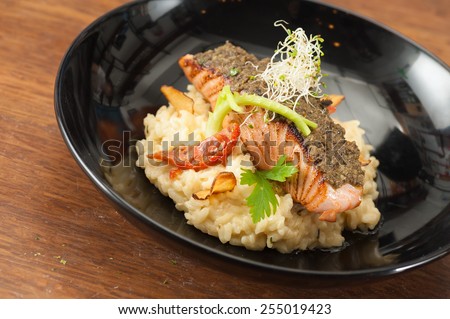 White wine lemon-sage risotto and sundried tomato with cured salmon tapenade, european fusion food