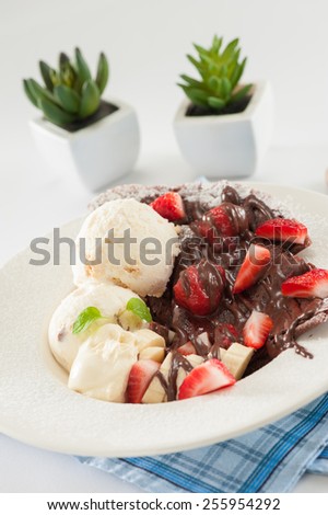 Gelato ice cream with crepe, chocolate sauce and fruits
