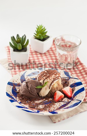 Chocolate ice cream with Tiramisu (Italian dessert) and strawberries.