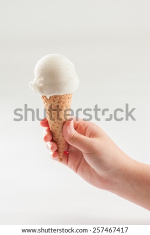 A woman hand holding Coconut ice cream scoop on cone