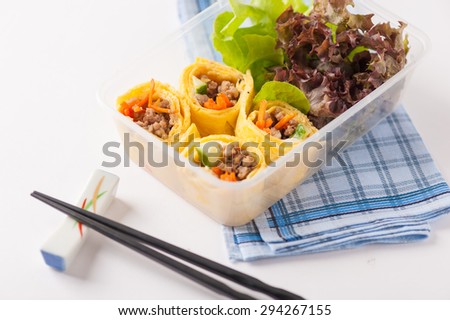 Thai spicy egg rolls (Fresh spring rolls, Kuay Teaw Lui Suan but use egg replace to rice sheet) with tofu, minced pork and vegetables cooked by clean food concept in lunch box