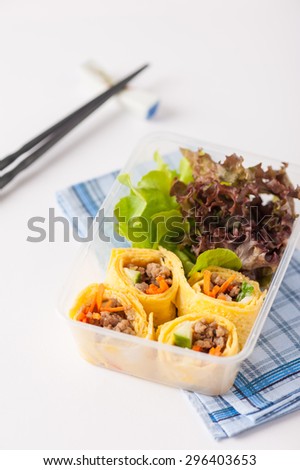 Thai spicy egg rolls (Fresh spring rolls, Kuay Teaw Lui Suan but use egg replace to rice sheet) with tofu, minced pork and vegetables cooked by clean food concept in lunch box