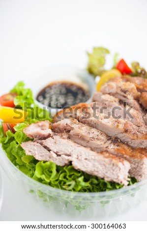 Grilled pork and teriyaki sauce (Japanese sweet sauce) cooked by clean food concept with salad in lunch box