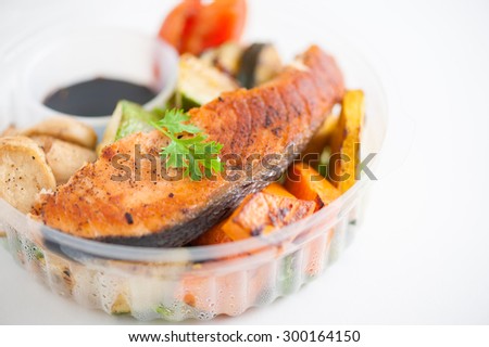 Salmon steak and grilled vegetables cooked by clean food concept with Japanese sesame soy sauce in lunch box