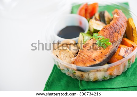 Salmon steak and grilled vegetables cooked by clean food concept with Japanese sesame soy sauce in lunch box