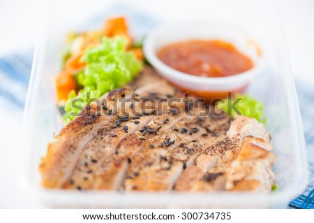 Roasted pork with three flavoured (sweet, sour, spicy) sauce cooked by clean food concept with vegetables in lunch box