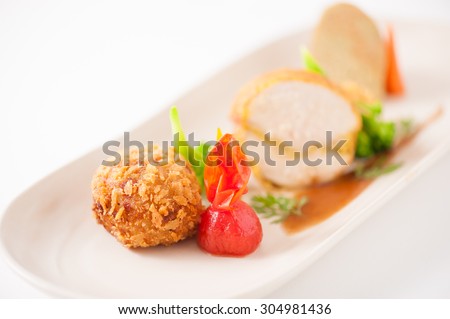 3 modern cuisine Prosciutto Wrapped Chicken with resotto and tamarind sauce, Fried mussaman curry, and Thai chicken spicy sausage on ceramic dish garnished with vegetables, focus on fried curry