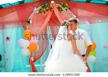 couple bride blonde and groom kissing on the wedding day dance
