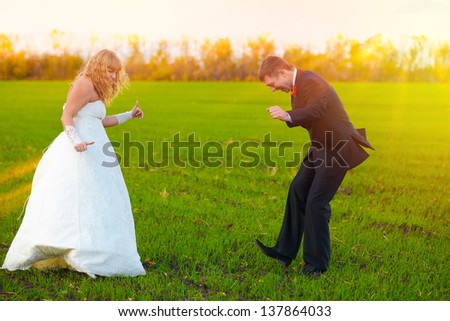 bride and groom sunlight dancing merrily in green field, couple, wedding fall
