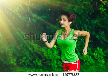 sunlight healthy beautiful brunette young woman athlete running outdoors, fitness and a healthy lifestyle, running