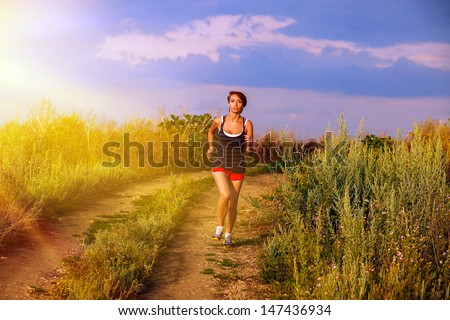 sunlight beautiful runs healthy young brunette woman athlete running outdoors, fitness and a healthy lifestyle, running