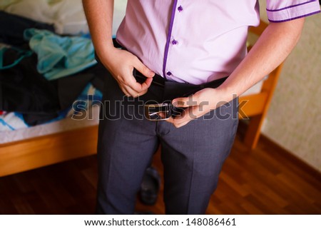 male businessman dressed in the morning is going to work, buttons pants