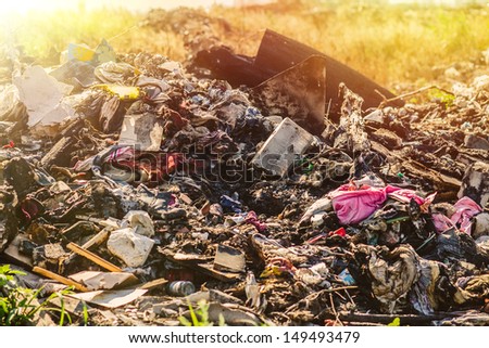 sunlight large pile of debris, city dump, pollution
