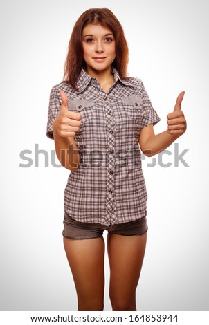 woman brunette young girl shows positive sign thumbs yes, shirt shorts isolated emotion