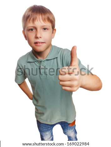 teenager boy kid in blue shirt holding thumbs up, showing blonde sign yes emotion isolated gray