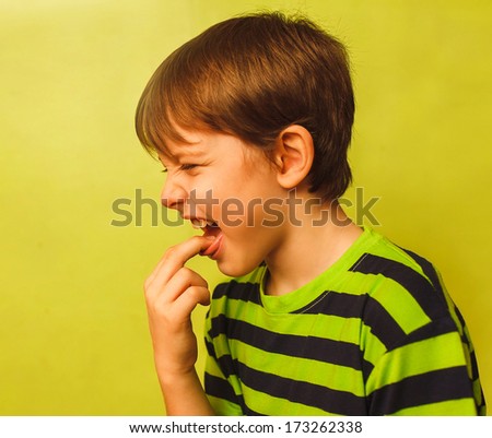 baby boy teenager poisoning vomiting belching, anorexia fingers in mouth burps on green background large