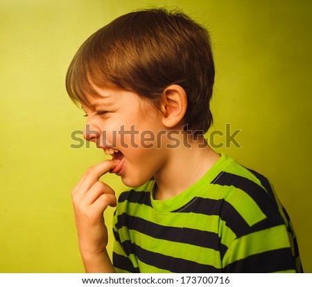 baby boy teenager poisoning vomiting belching,  fingers in mouth burps on green background gray large