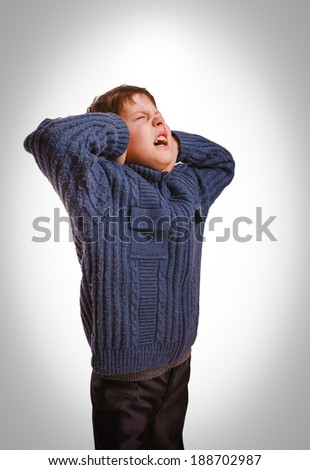 gray teenager boy child covered his ears screaming opened his mouth and closed eyes isolated on white background