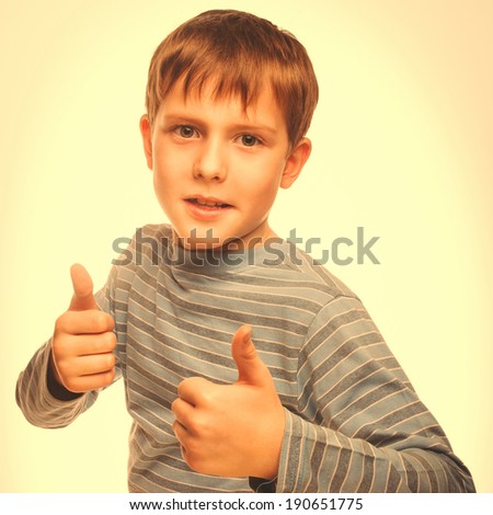 boy kid blonde in striped jacket holding thumbs up, showing sign yes studio isolated large cross processing retro