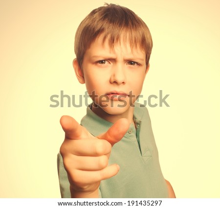 Angry boy shows his finger to screen evil is isolated on white background emotion gray large cross processing retro
